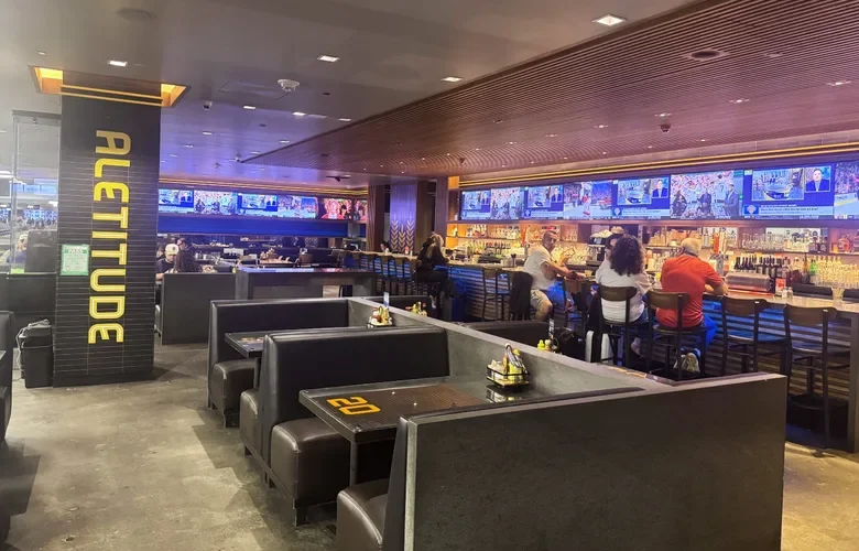 Seating area and TV screens at Aletitude restaurant, SFO